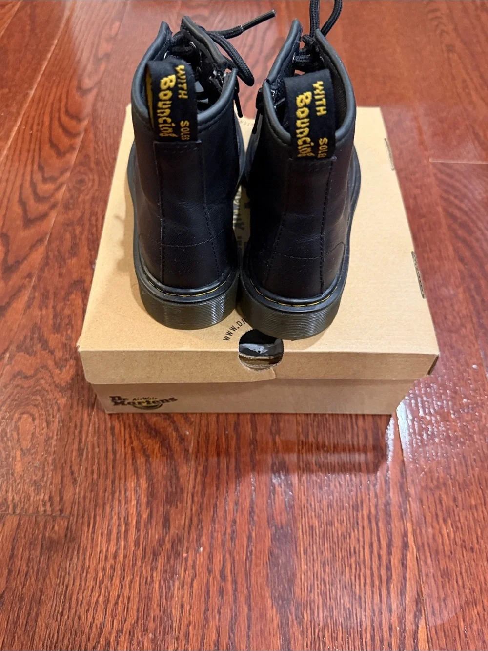 Dr. Martens Black Leather 8-Eye Lace-Up Boot with Yellow Heel Loop